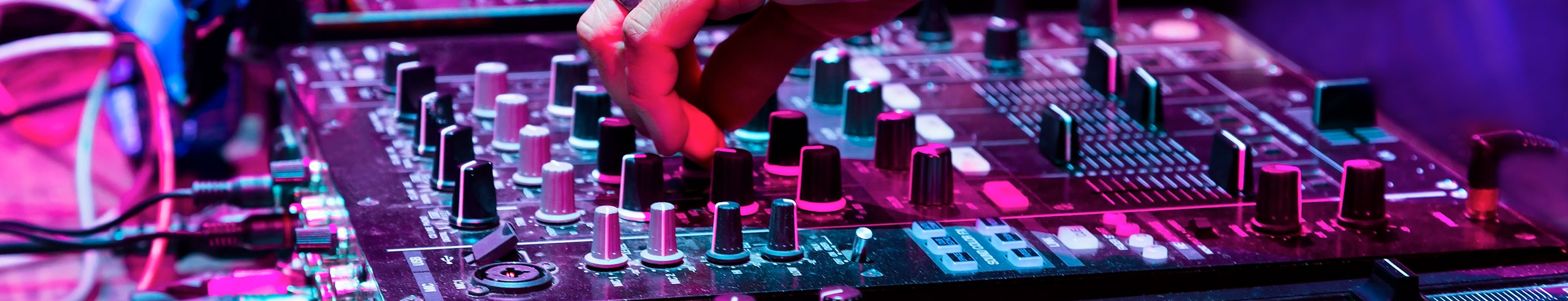 Hand eines DJ's auf einem Mischpult